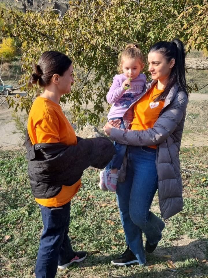 VIVA charity volunteer speaking with a mother and child in rural Armenia